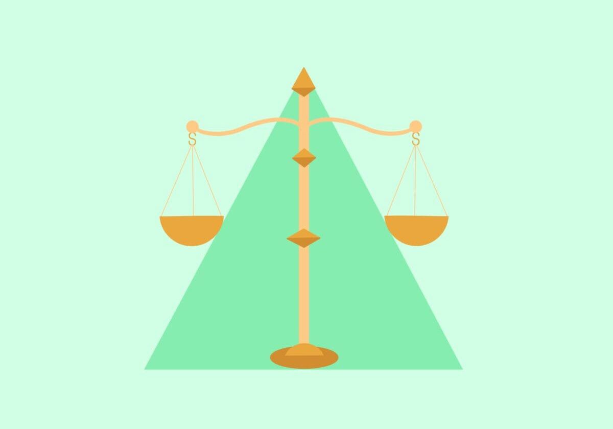 Golden scales of justice on green background.